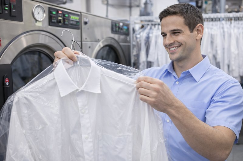 WashMate dry cleaner inspecting a white shirt during summer stain removal in Sydney